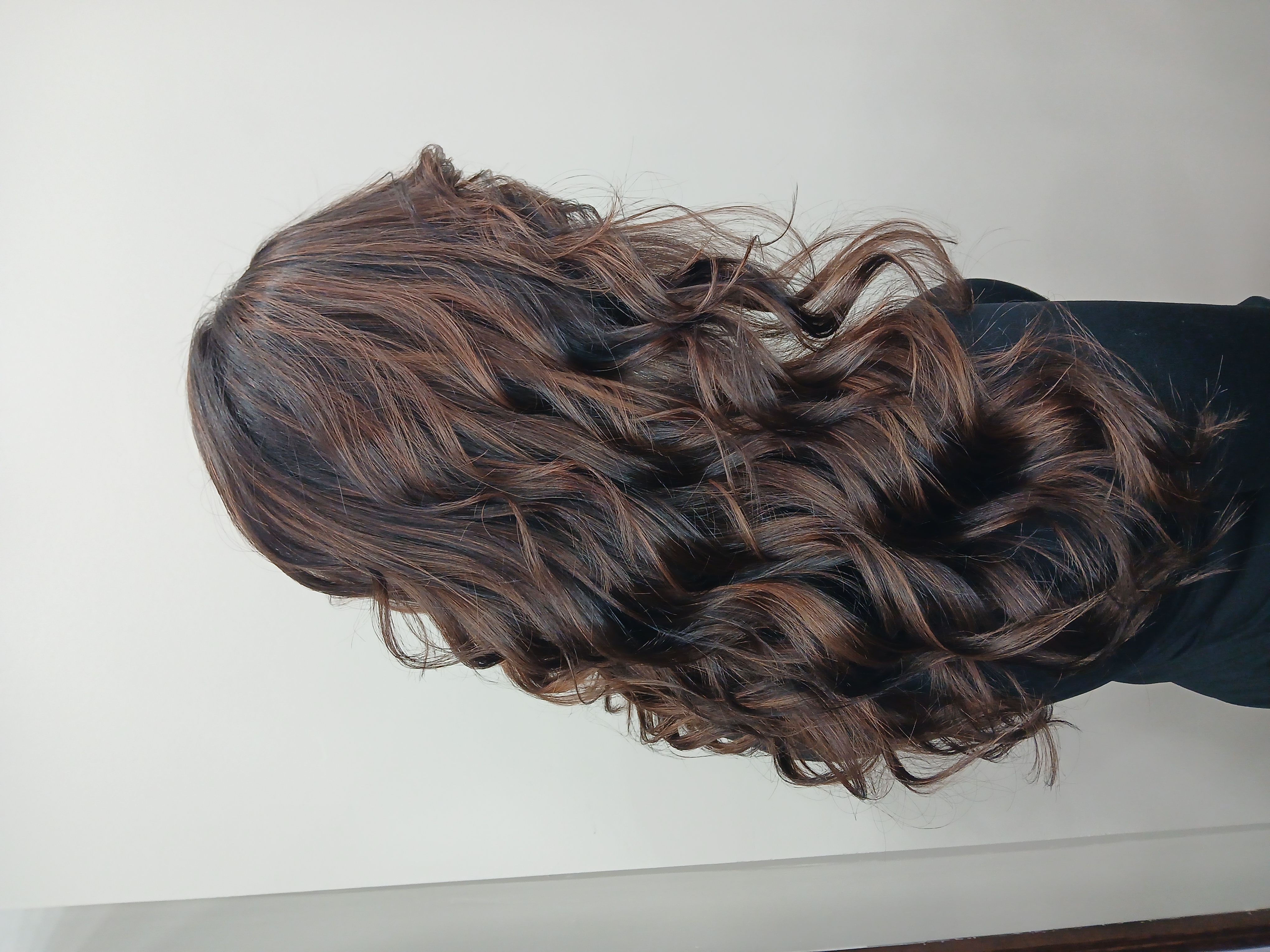Rich brunette curls with dimensional highlights