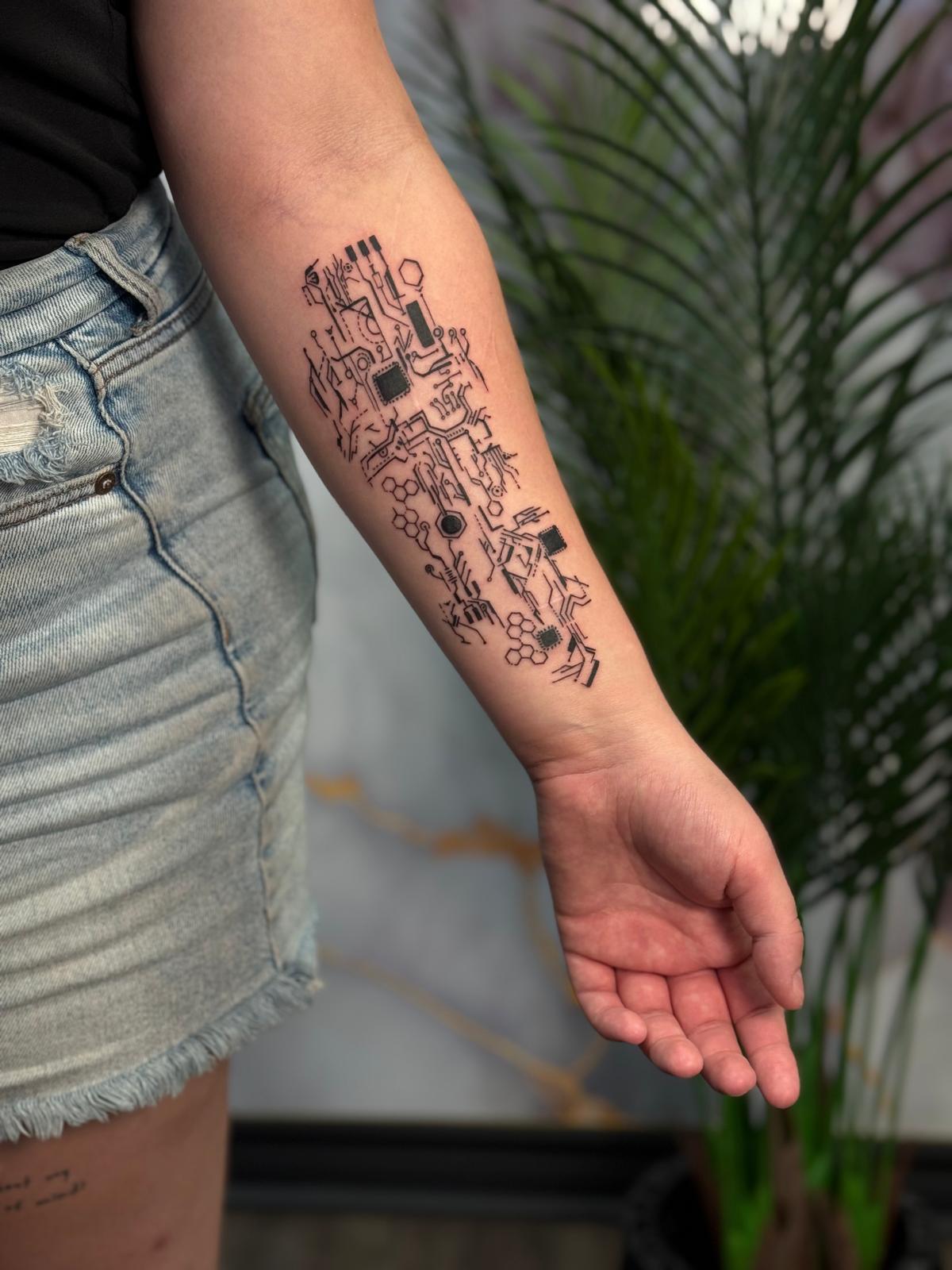 Fine line lotus and lettering tattoo